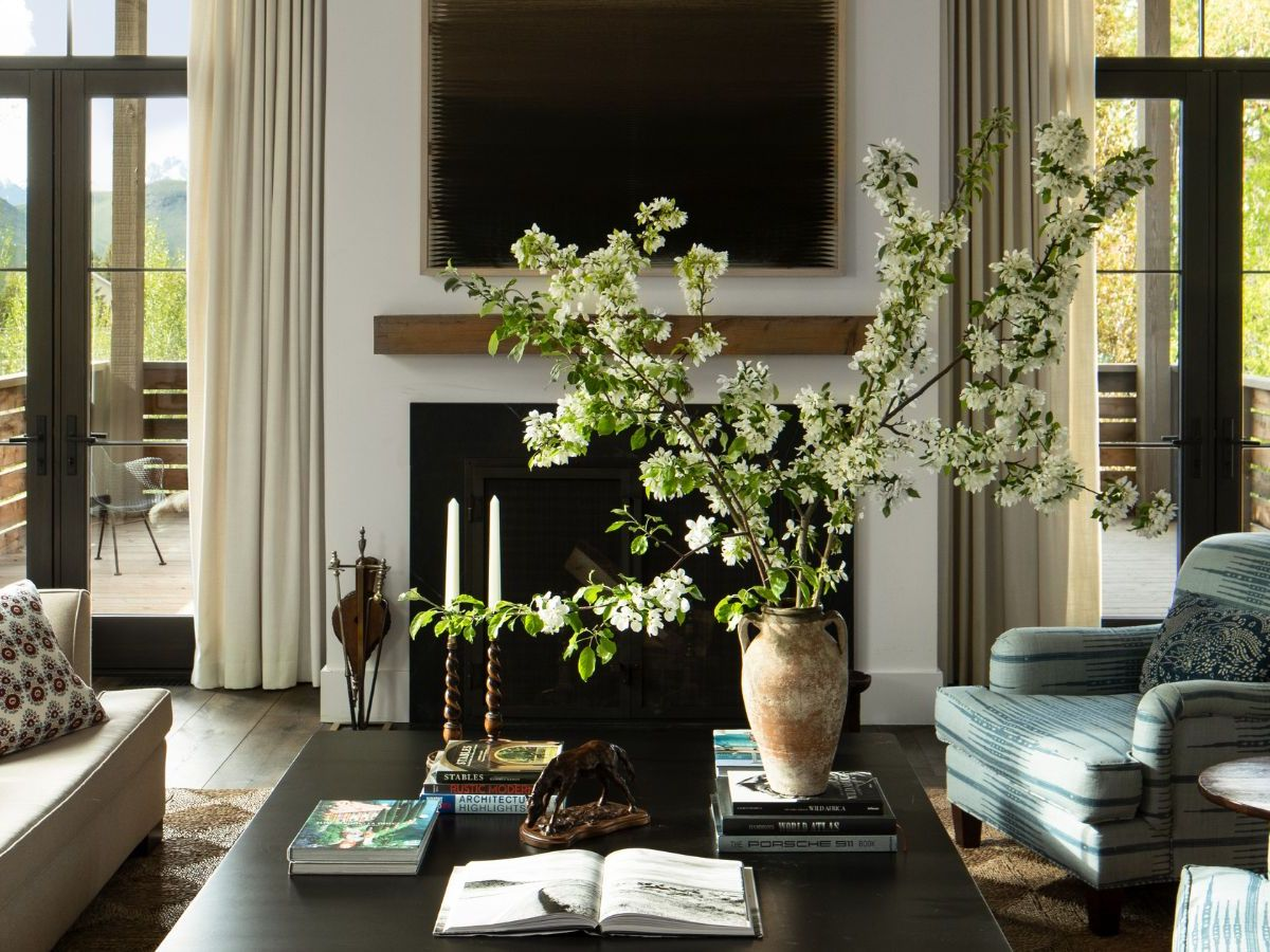 Spring organic modern materials mood scene featuring linen, limewash texture, warm wood, and stone elements