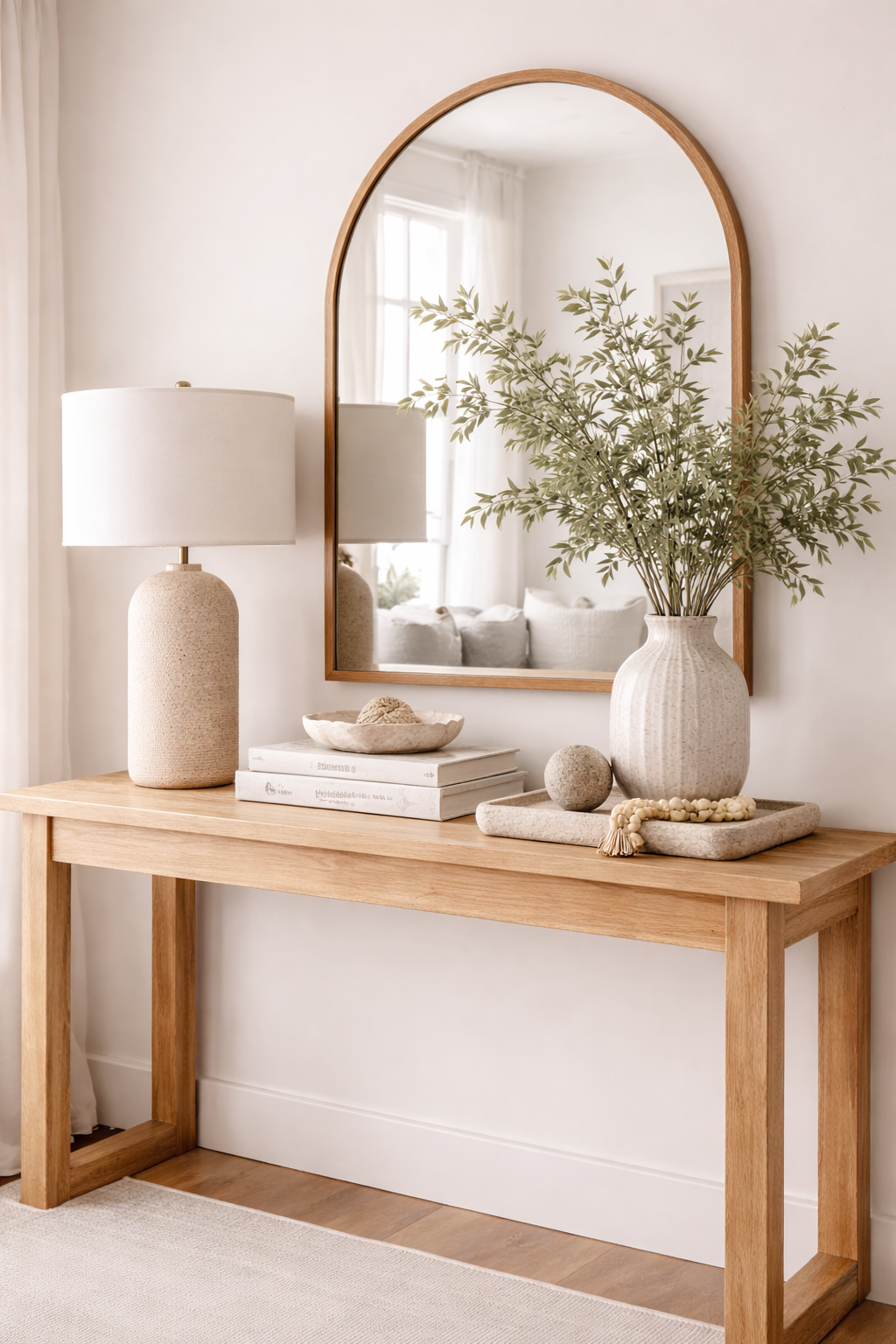 Minimal organic modern console table with arched mirror, neutral decor, and soft spring styling